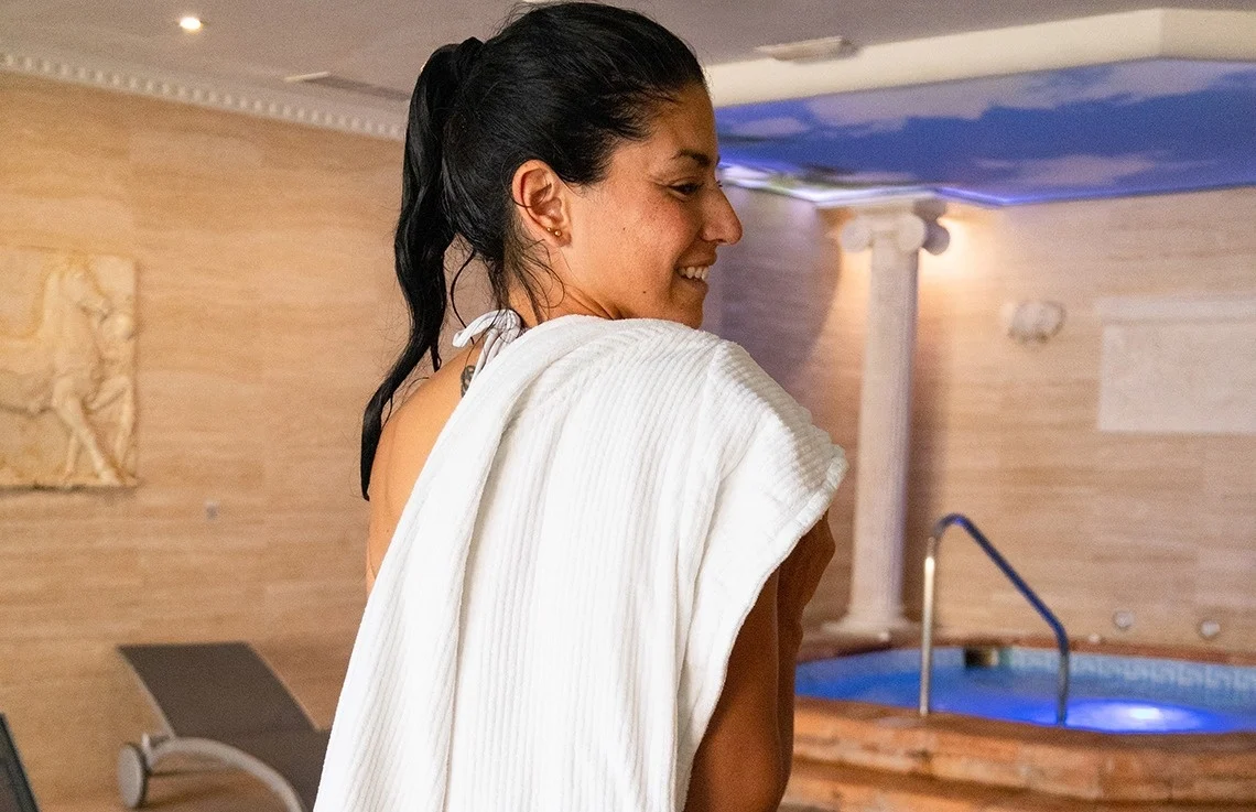 Guest smiling after a treatment by the jacuzzi at Amaragua Spa, Torremolinos