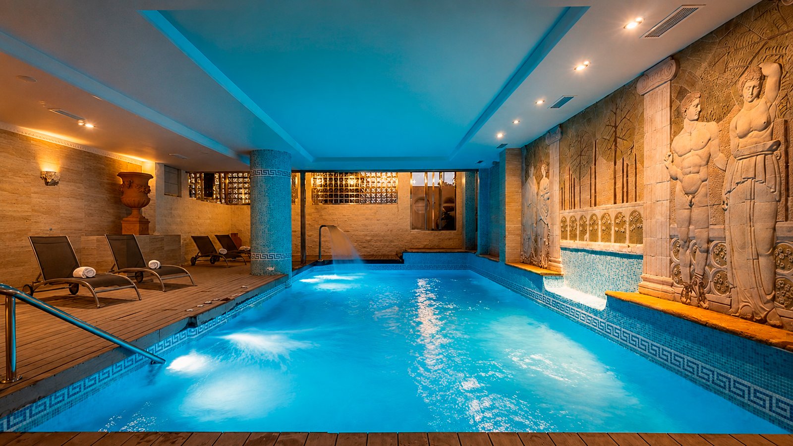 Indoor heated pool at Hotel MS Amaragua's spa in Torremolinos, with stone arches and warm light